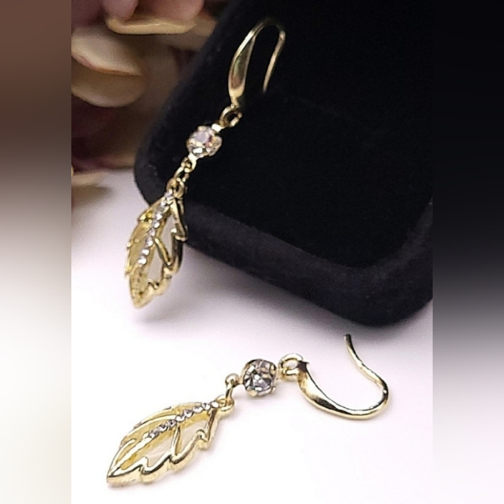 Elegant gold dangle earrings with rhinestones and leaf accent. New!